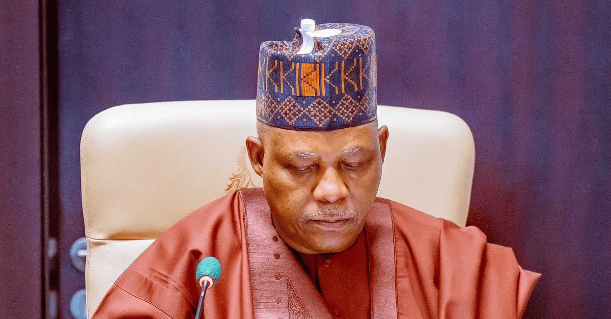 Vice President Shettima speaking at a podium in Jos, Nigeria