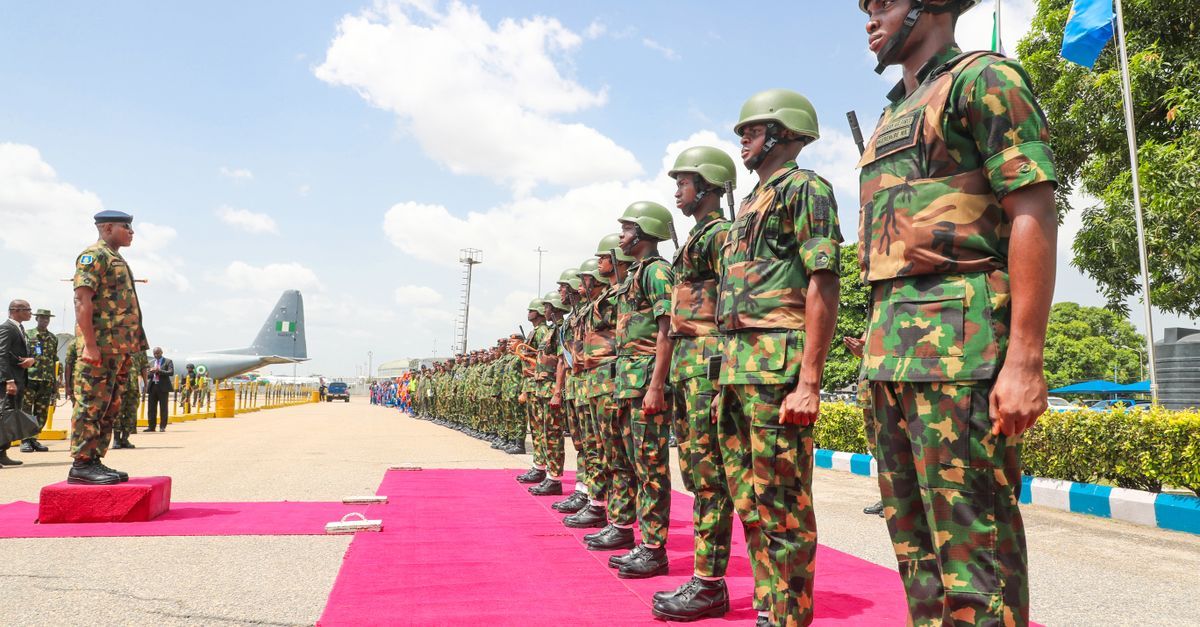 Nigerian troops in uniform boarding a military aircraft for deployment