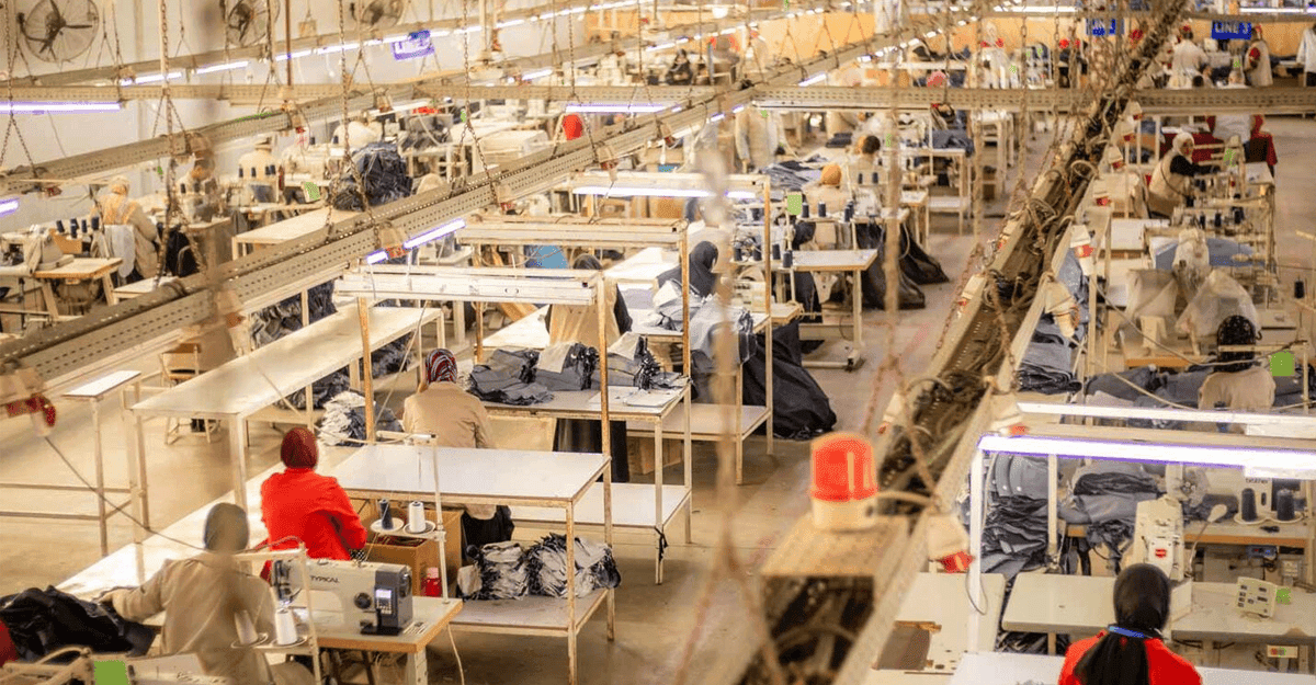 Cotton bales in an African factory with workers processing textiles