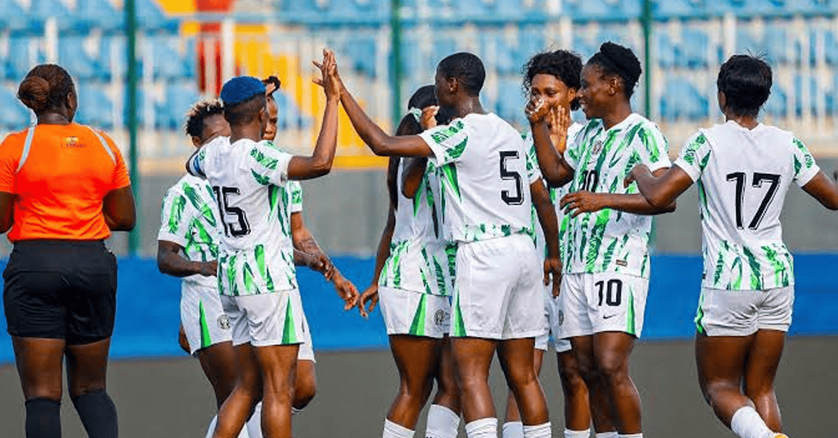 Super Falcons players celebrating on the pitch after their WAFCON victory over Zambia.