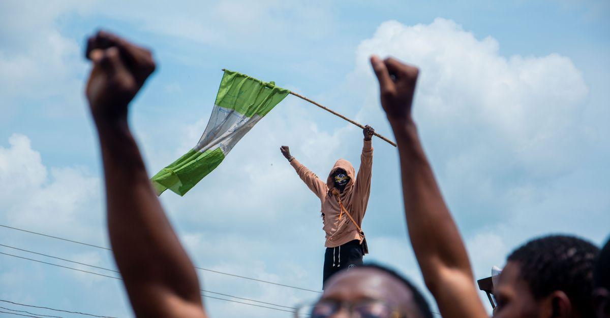 Nigerien flag waving in front of government building in Niamey